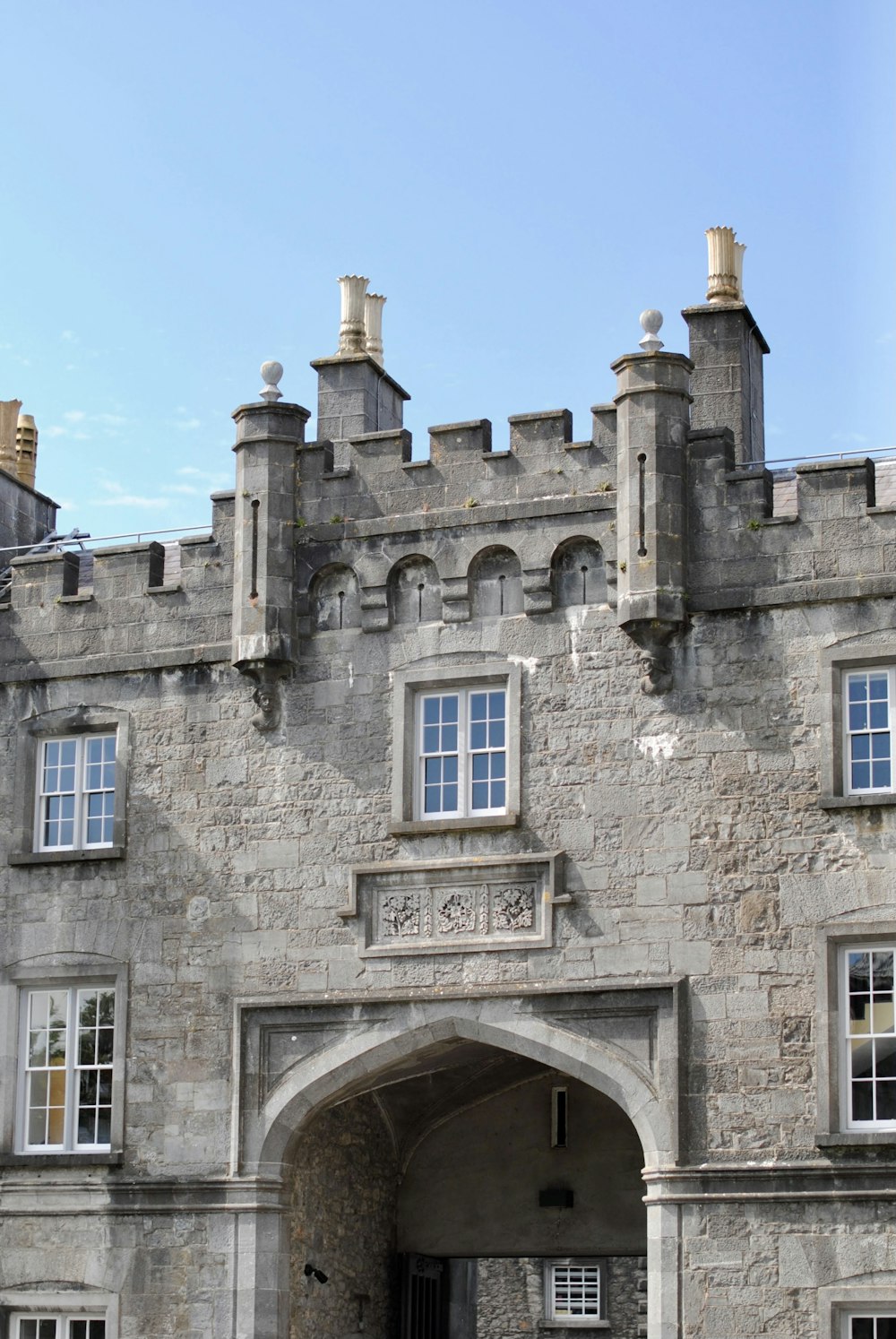 a large stone building with a clock on the front of it