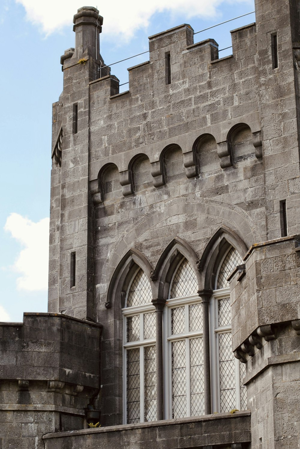 a large stone building with a clock on it's side