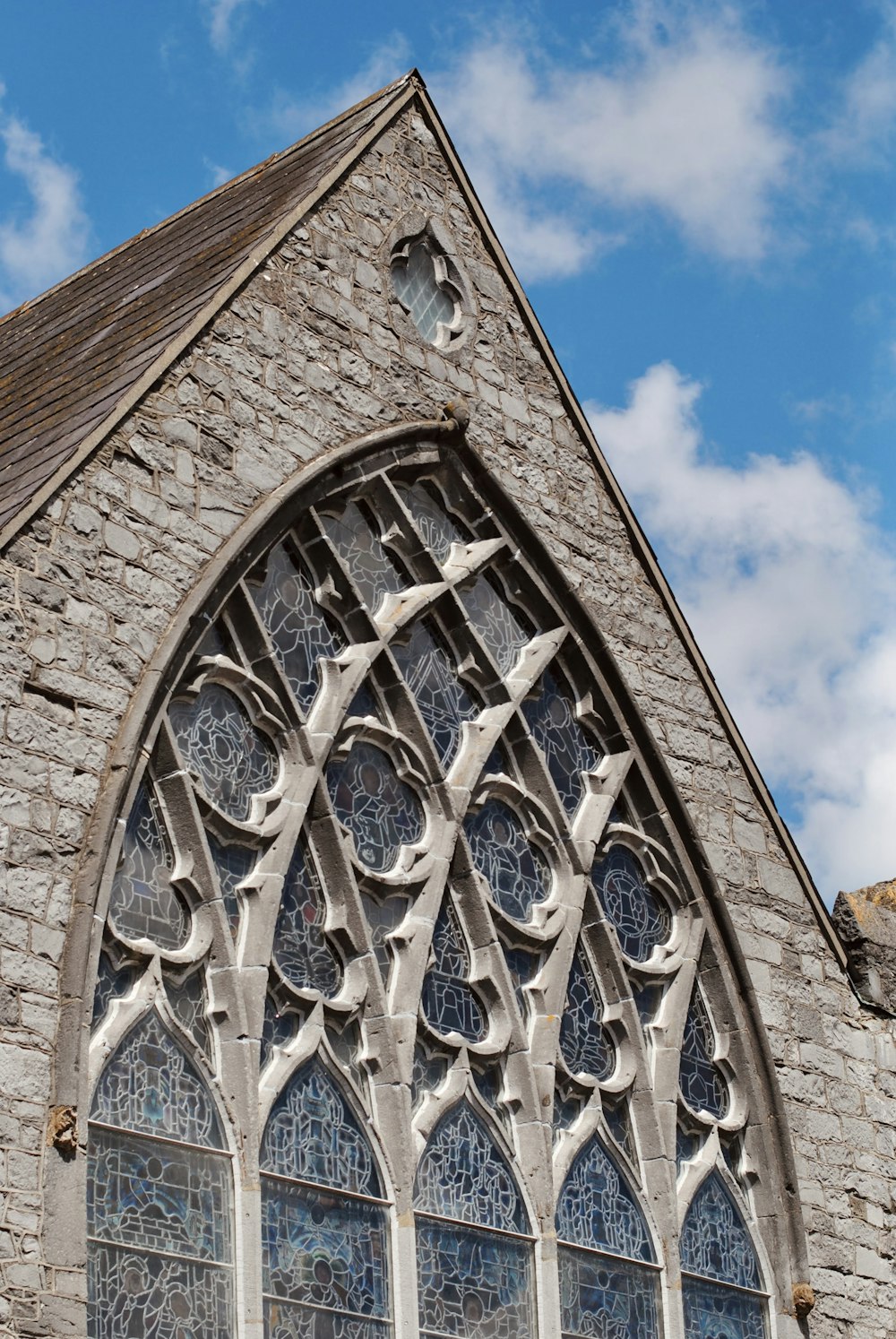 a large stone building with a very tall window