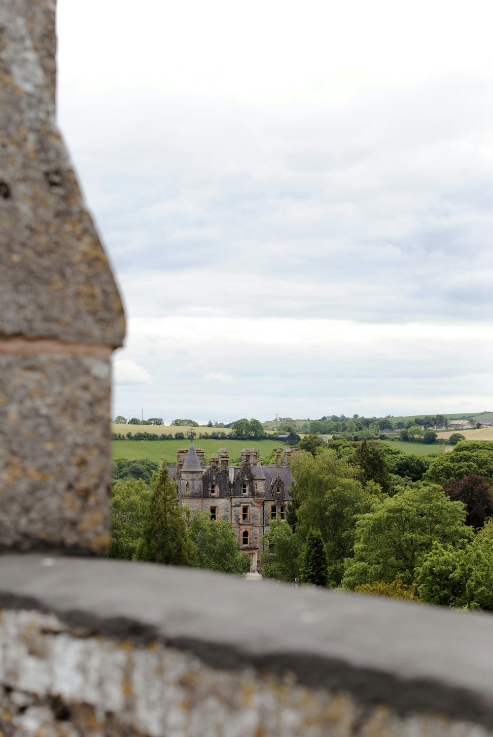 a view of a castle through a stone wall