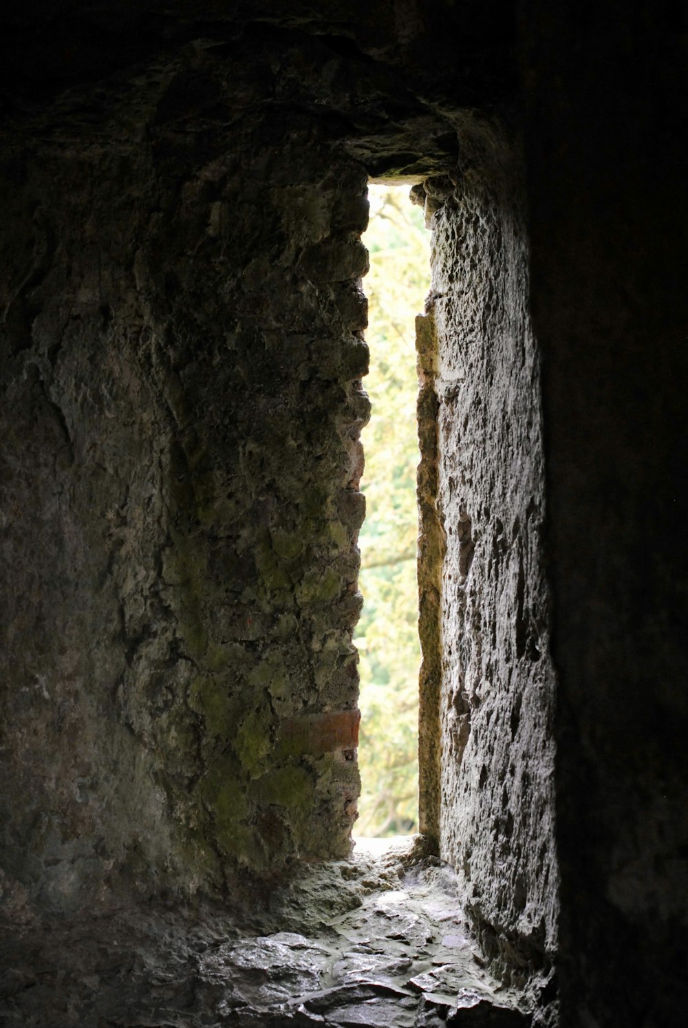 an open window in a stone wall in a cave