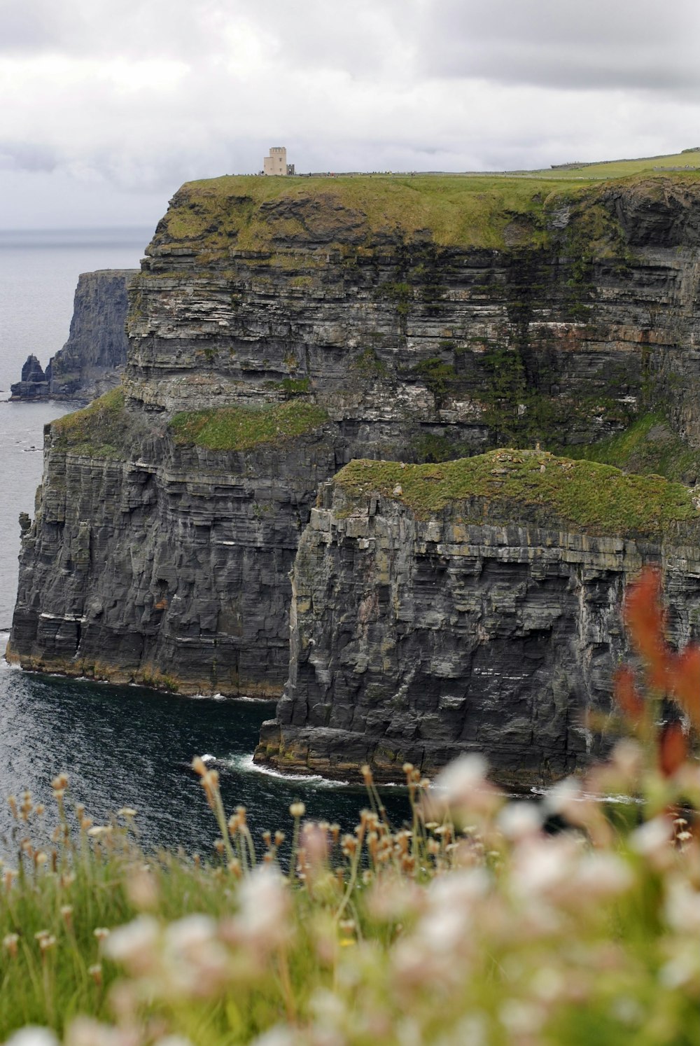 a view of a cliff with a lighthouse on top of it