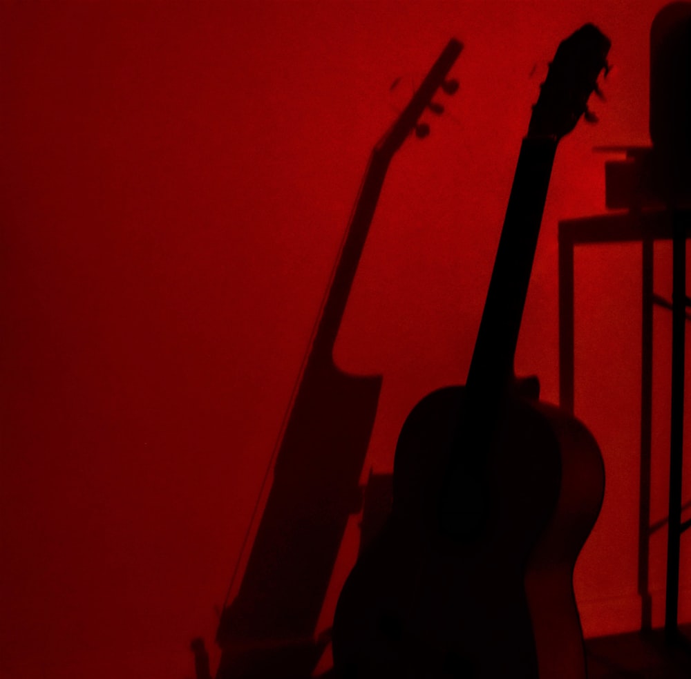 a guitar sitting in the corner of a room