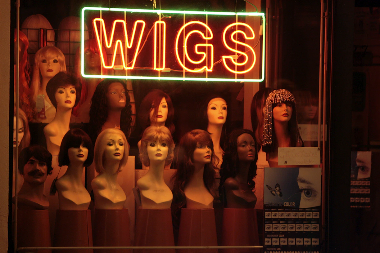 a display of wigs in a store window