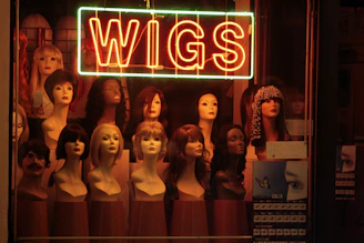 a display of wigs in a store window