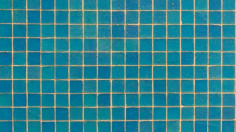 a close up of a blue tiled wall