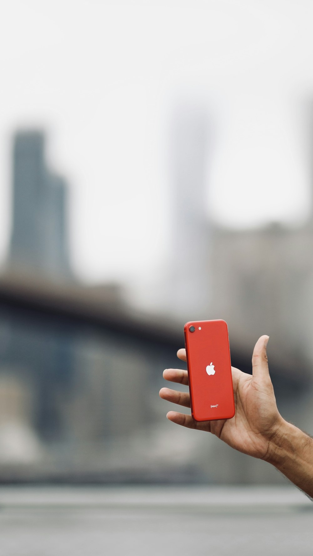 a person holding an apple phone in their hand