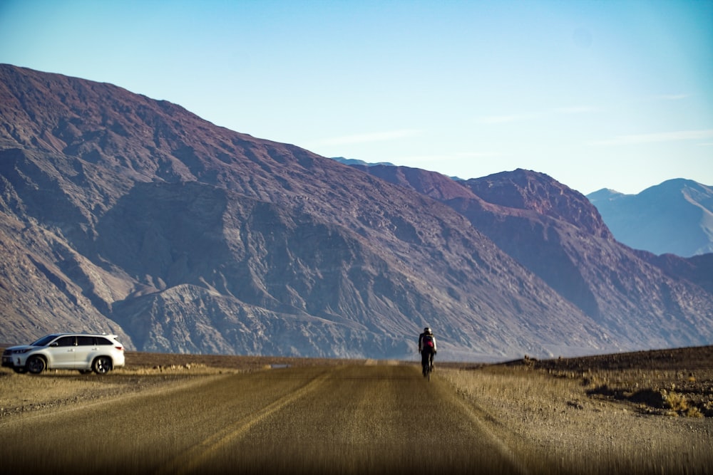 a person riding a motorcycle down a dirt road