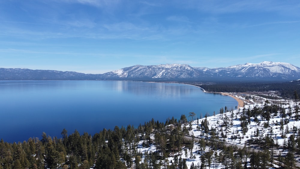 a large body of water surrounded by snow covered mountains