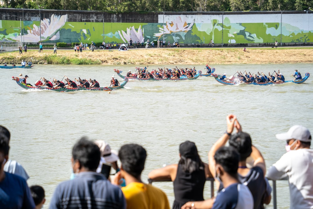 a group of people watching a dragon boat race