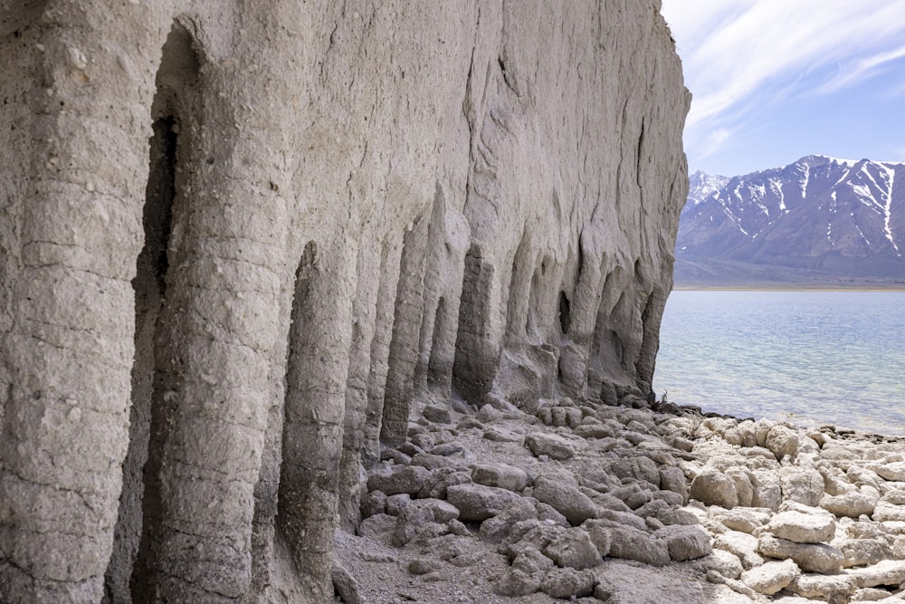 a large rock formation next to a body of water