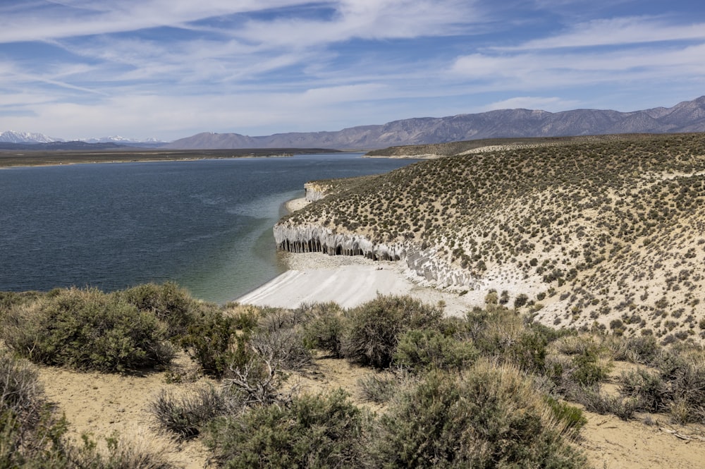 a body of water surrounded by a desert landscape