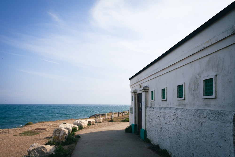 a white building sitting next to a body of water