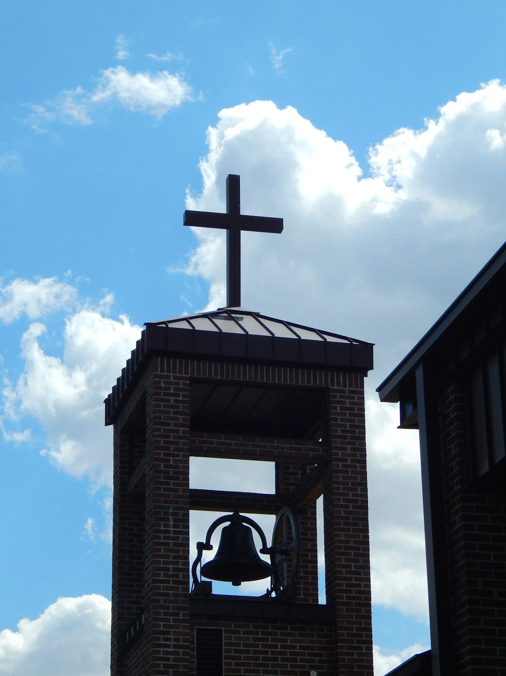 a bell tower with a cross on top of it