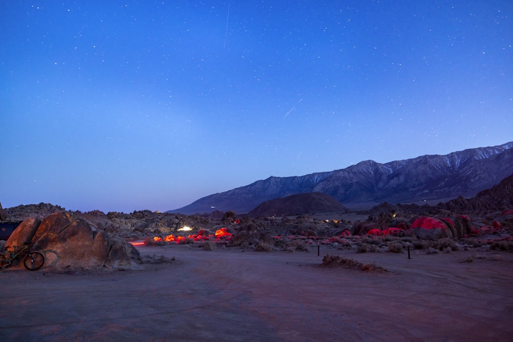 a desert landscape with a mountain range in the background