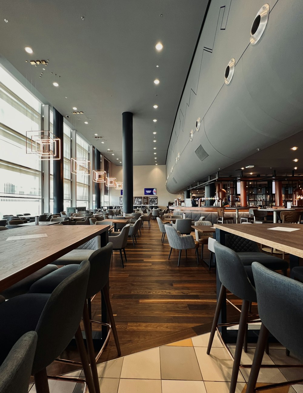 a restaurant filled with lots of tables and chairs