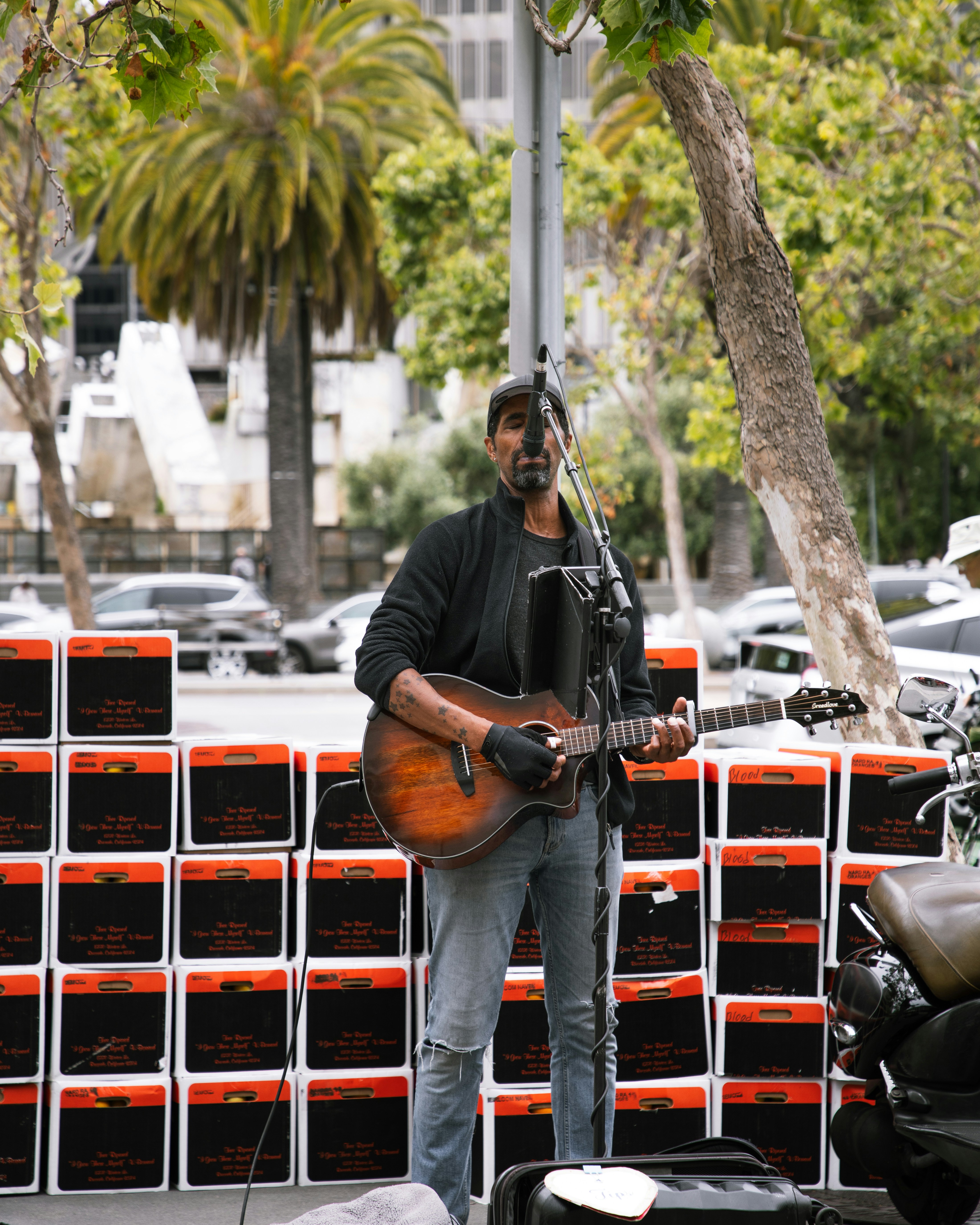 a man playing a guitar on the street