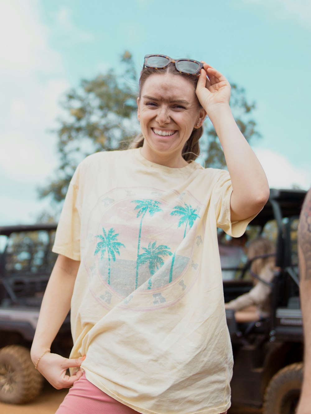 a woman in a yellow shirt and pink shorts