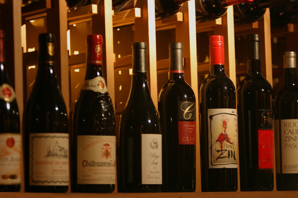 a bunch of bottles of wine sitting on a shelf