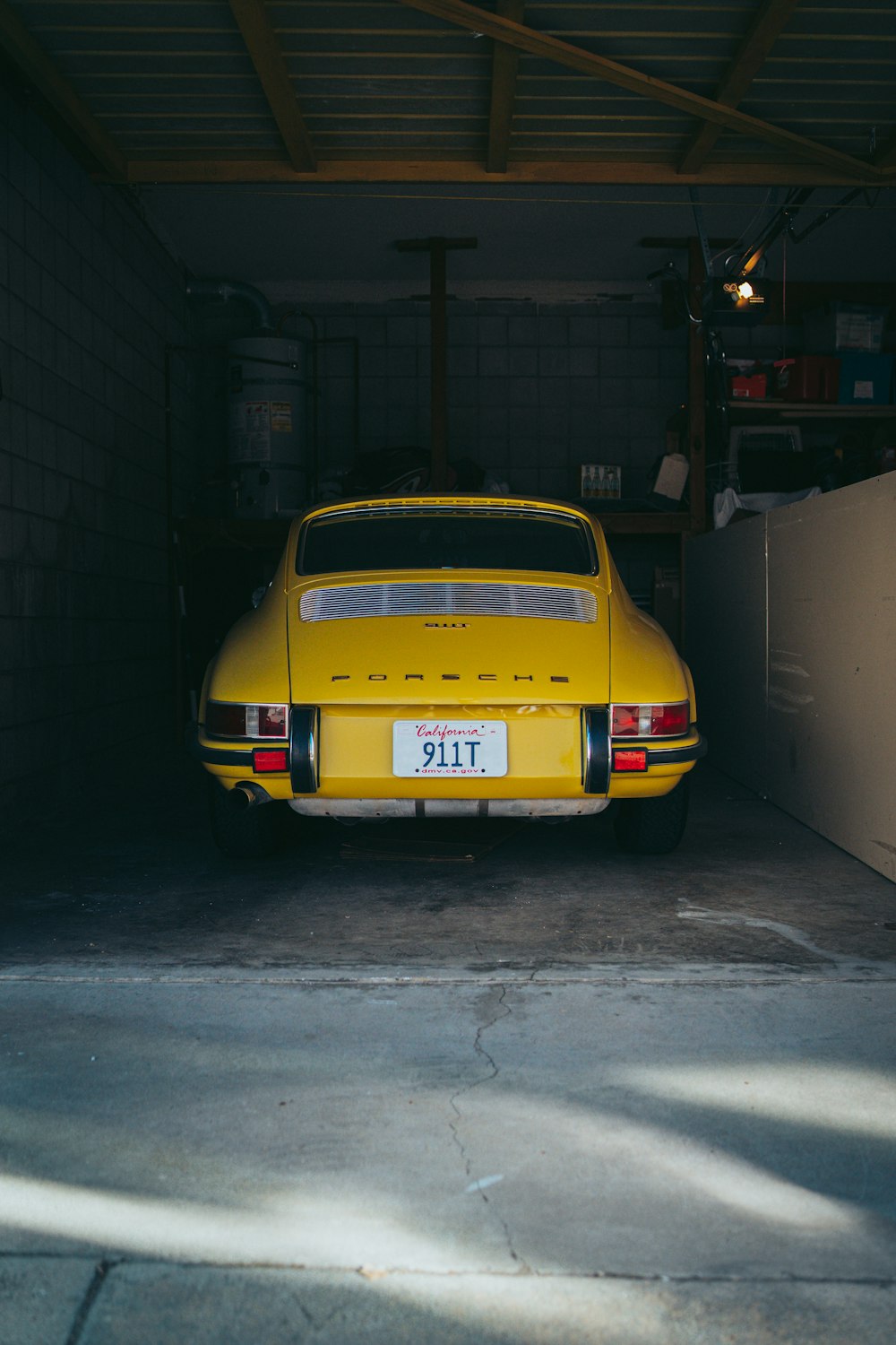 a yellow car is parked in a garage
