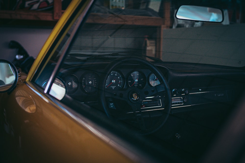 the interior of a car with a steering wheel and dashboard