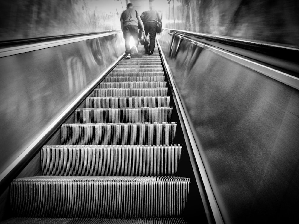 a couple of people walking down a set of stairs