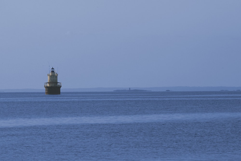 a light house in the middle of a large body of water