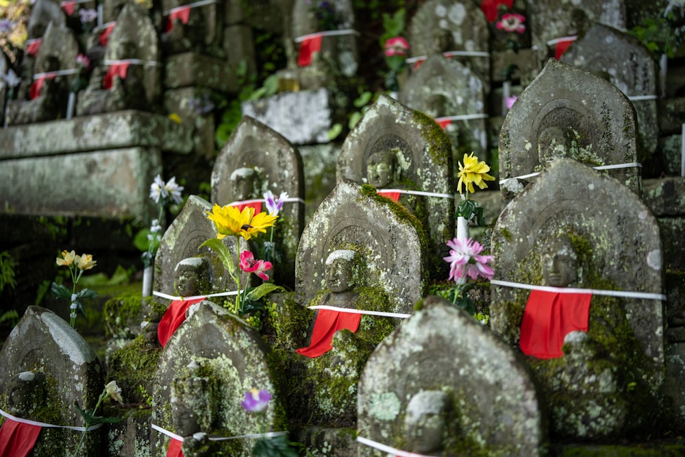 a bunch of rocks with flowers tied to them