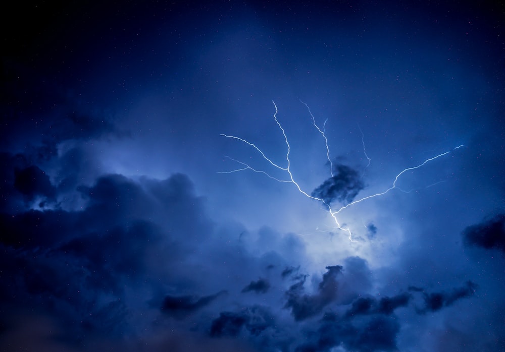 a lightning bolt hitting through a cloudy sky