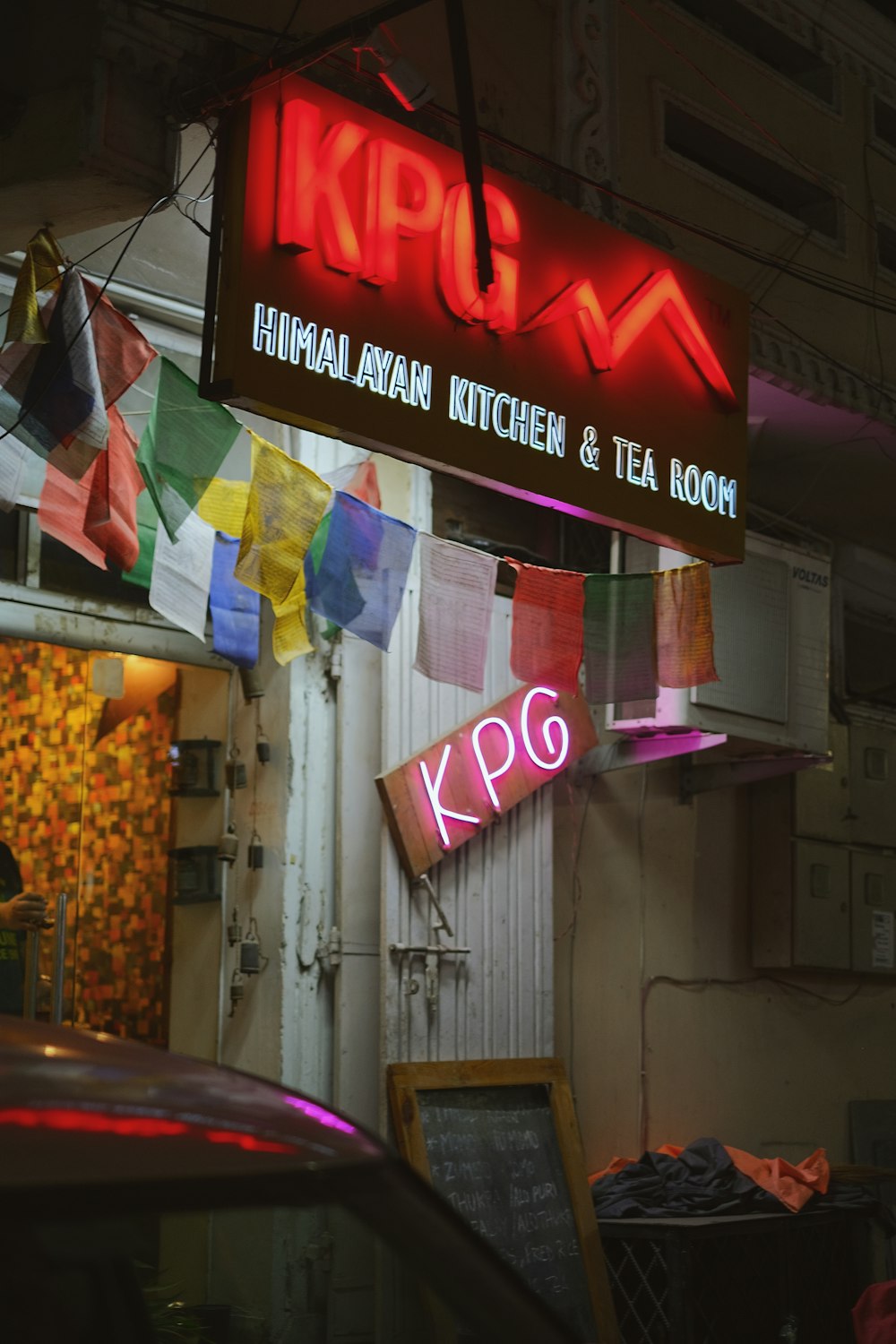 a neon sign hanging from the side of a building