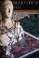 Close-up of a detailed Roman bust showing intricate craftsmanship.