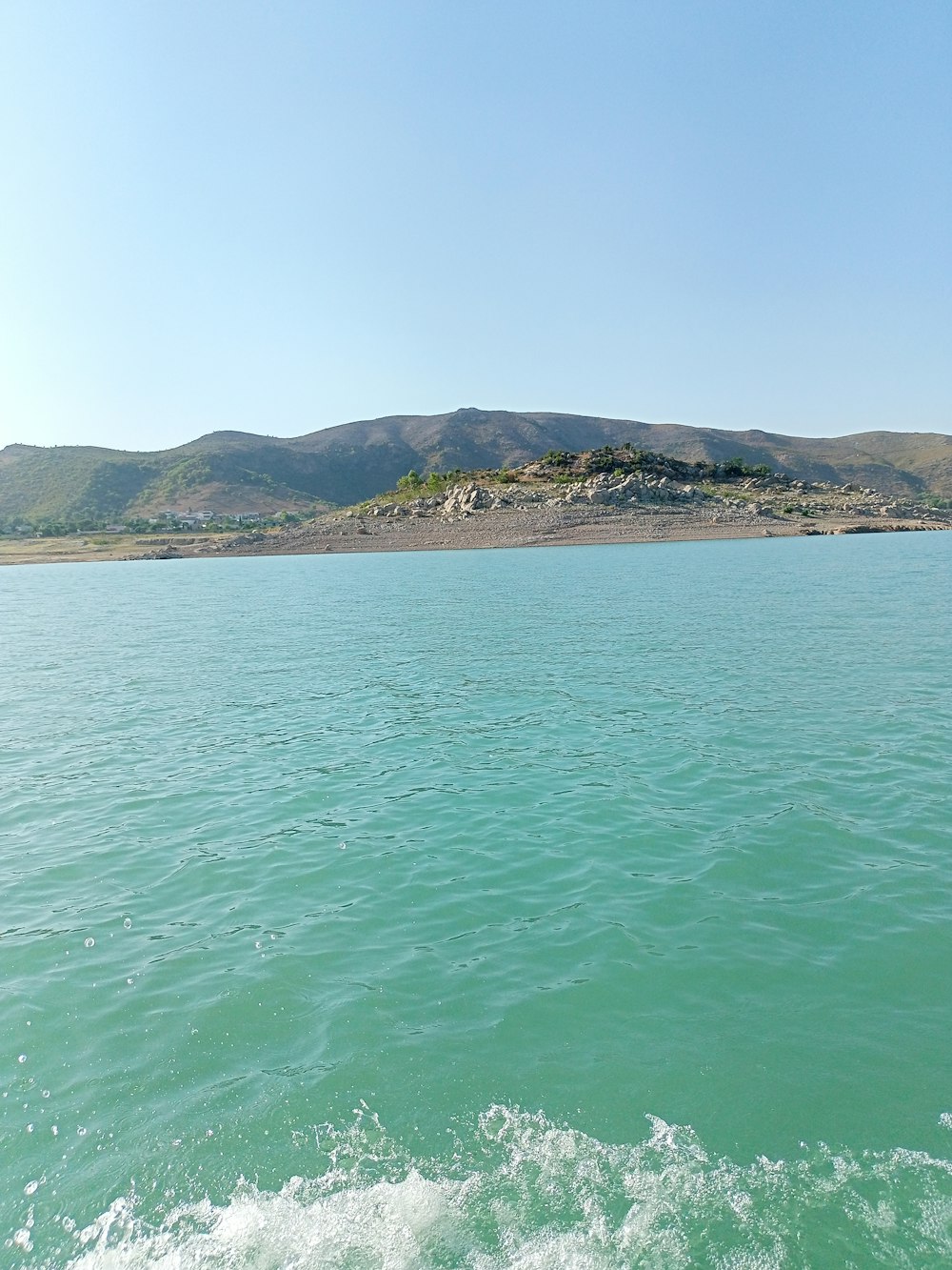 a body of water with mountains in the background