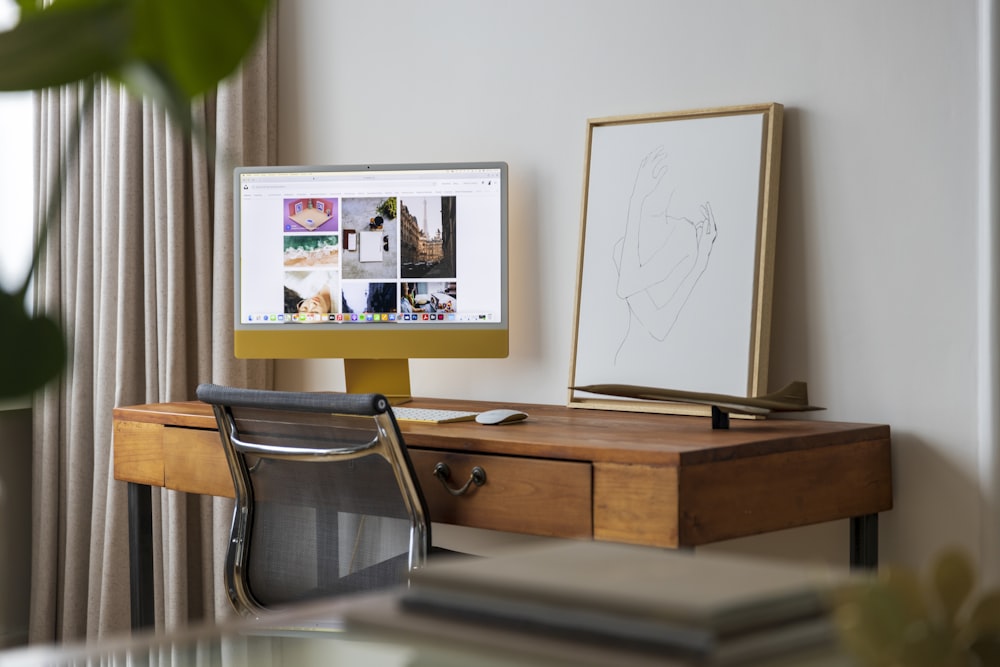 a desktop computer sitting on top of a wooden desk