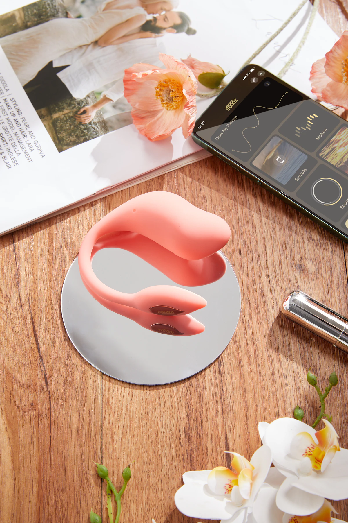 Coral couples massager on a wooden table