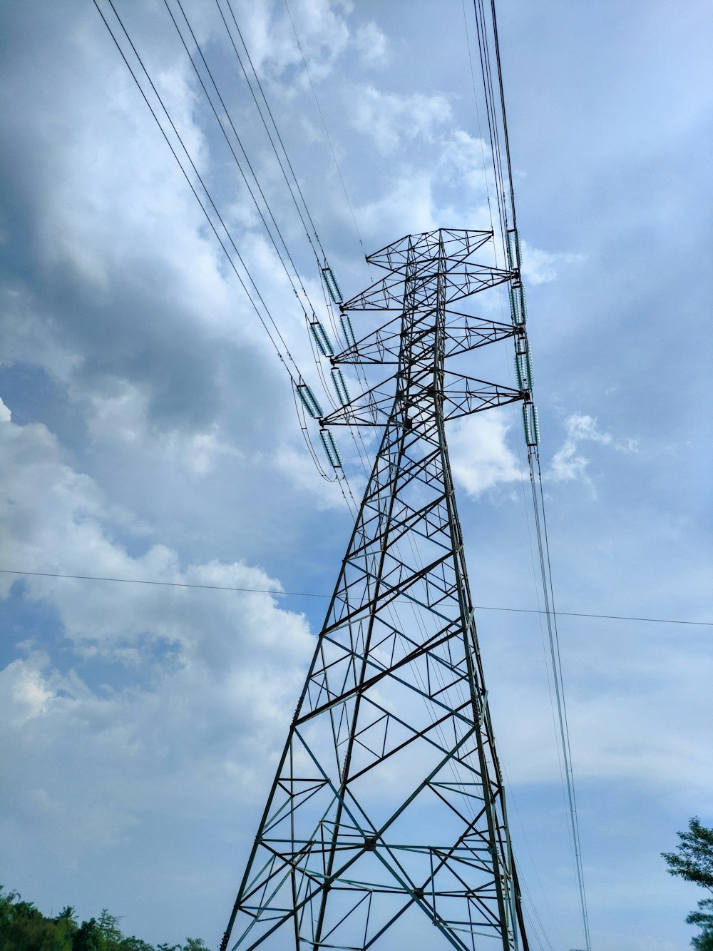 a tall metal tower sitting under a cloudy blue sky