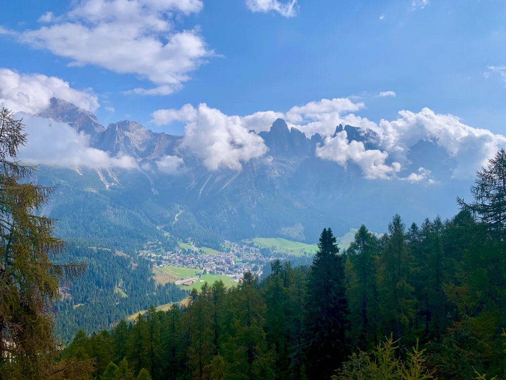 a view of a mountain range with trees and mountains in the background