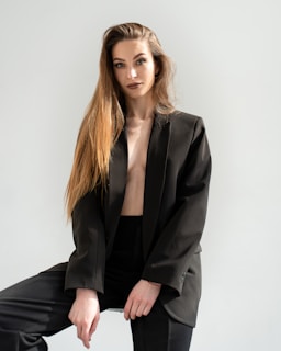 a woman in a black suit posing for a picture