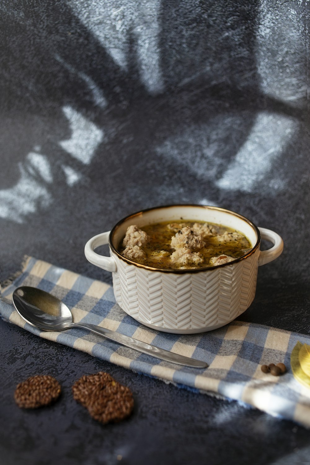 a bowl of soup on a table with a spoon