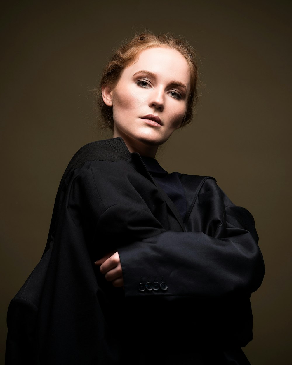 a woman in a black coat posing for a picture