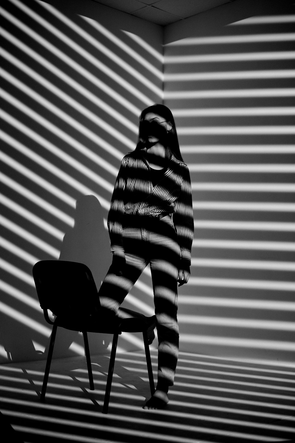 a person standing in a room with a chair
