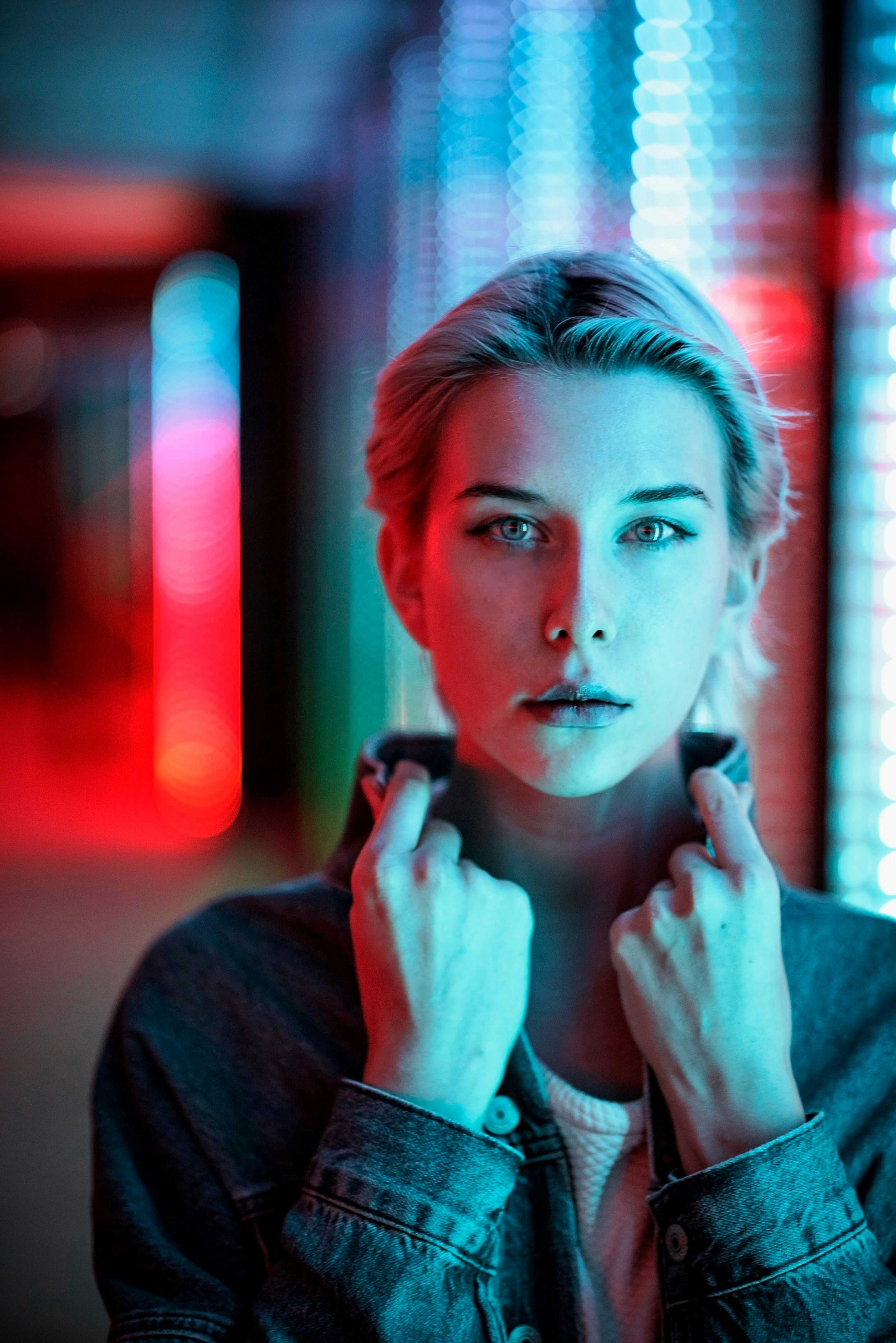 A woman is standing in a dark room photo – Free Street portrait ...
