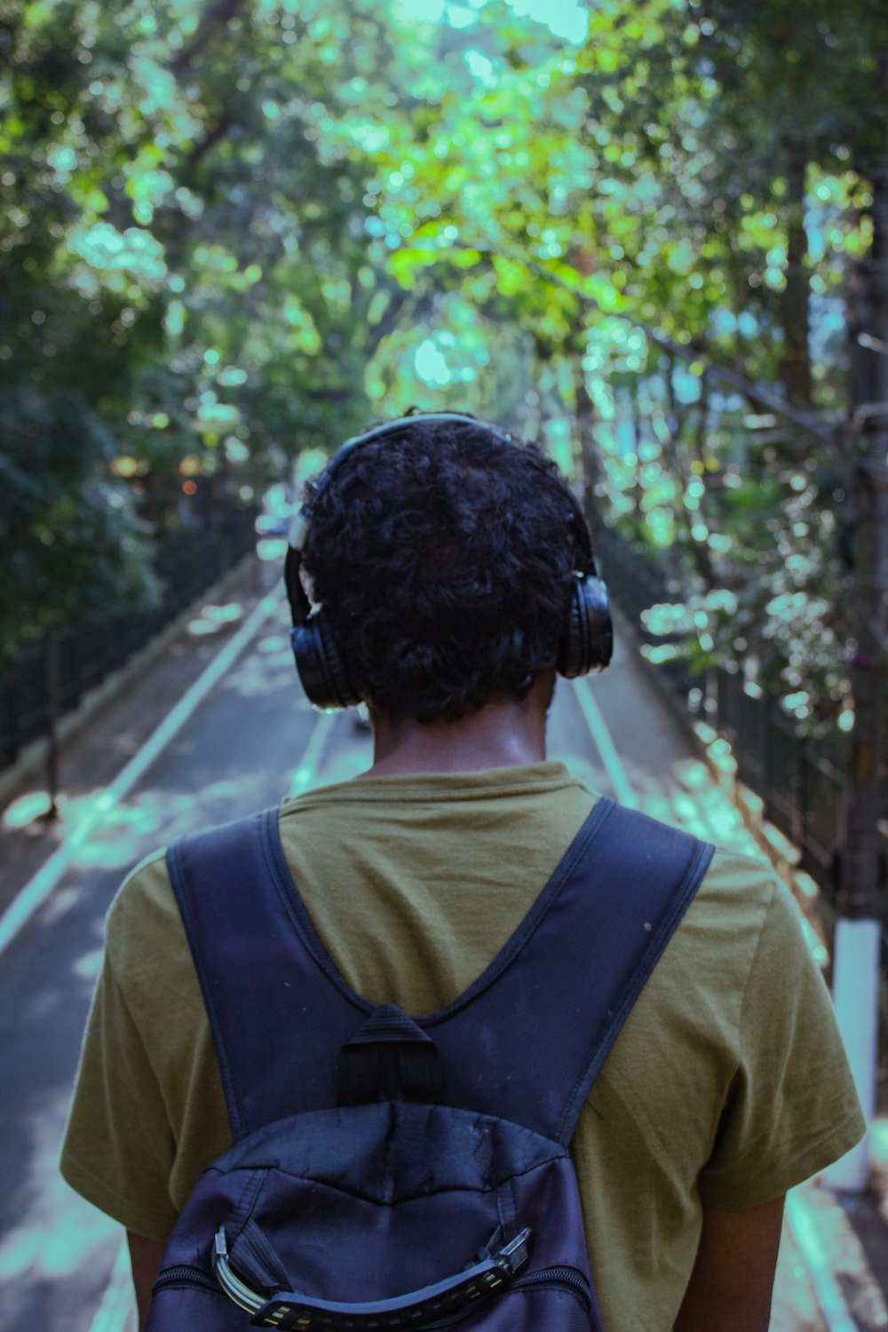 a person with headphones on walking down a street