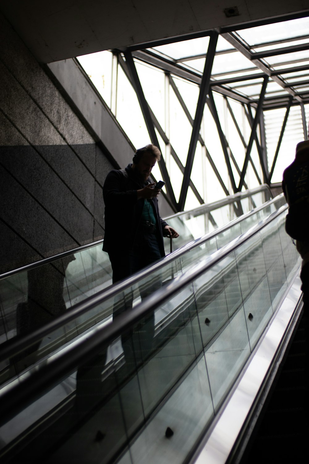 a couple of people that are standing on an escalator