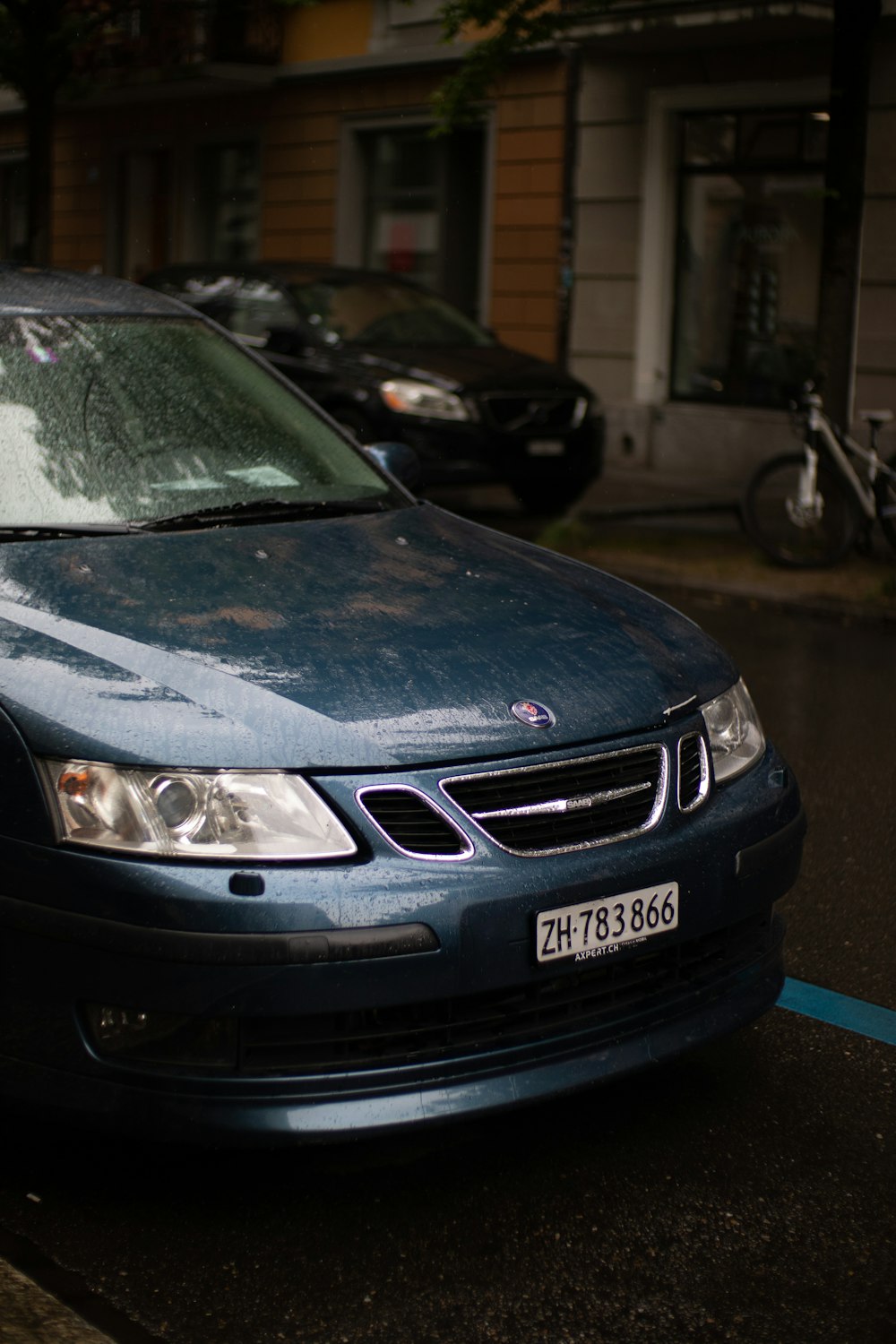 a blue car parked on the side of the road