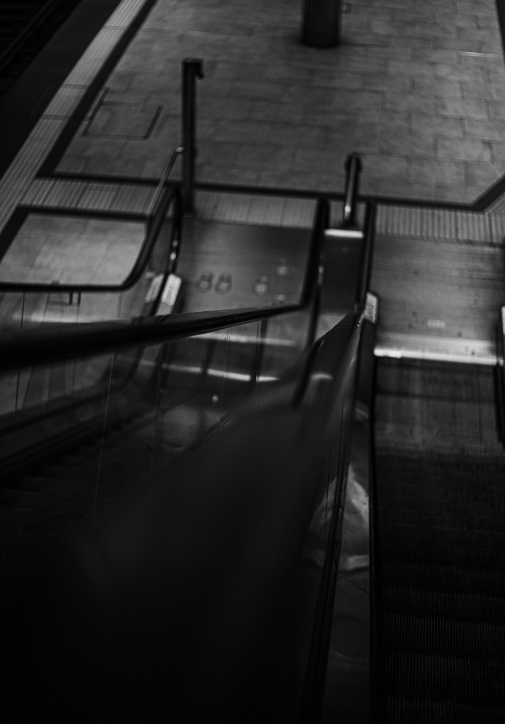 a person riding an escalator down a flight of stairs