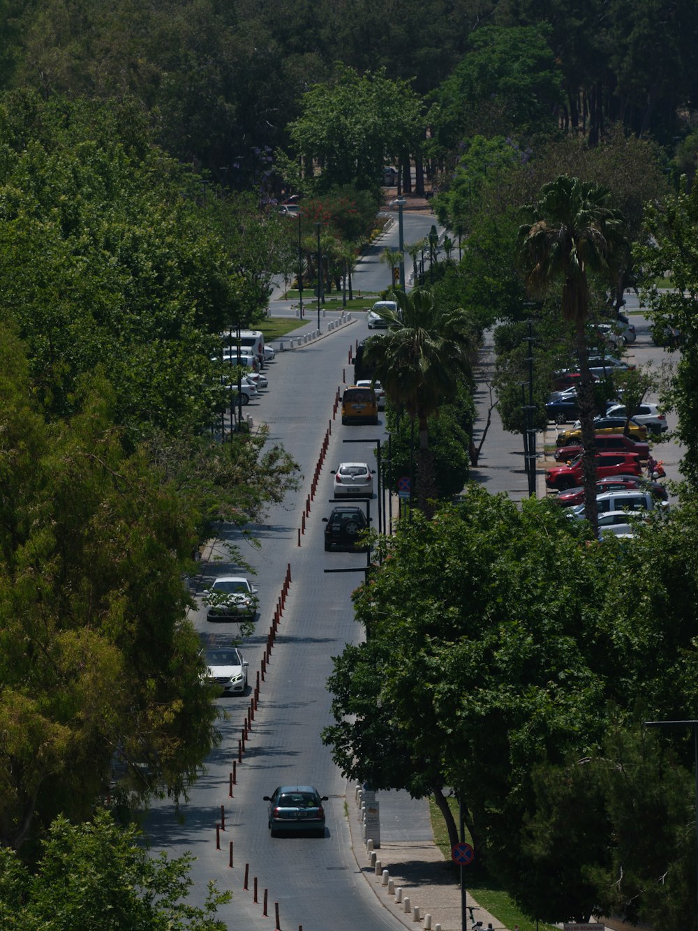 a view of a street with cars parked on both sides of it