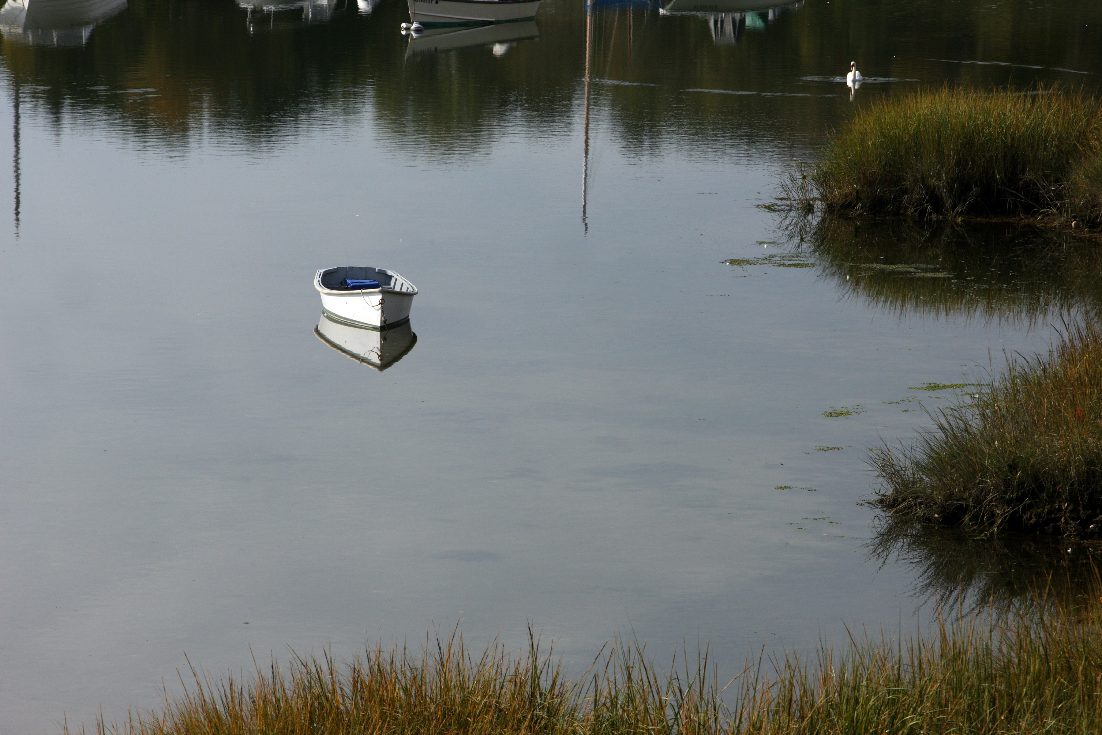 a small boat floating on top of a body of water