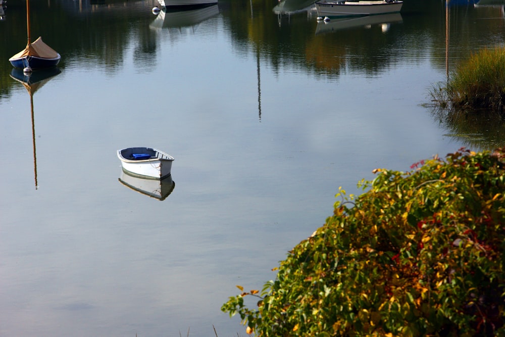 a small boat floating on top of a body of water