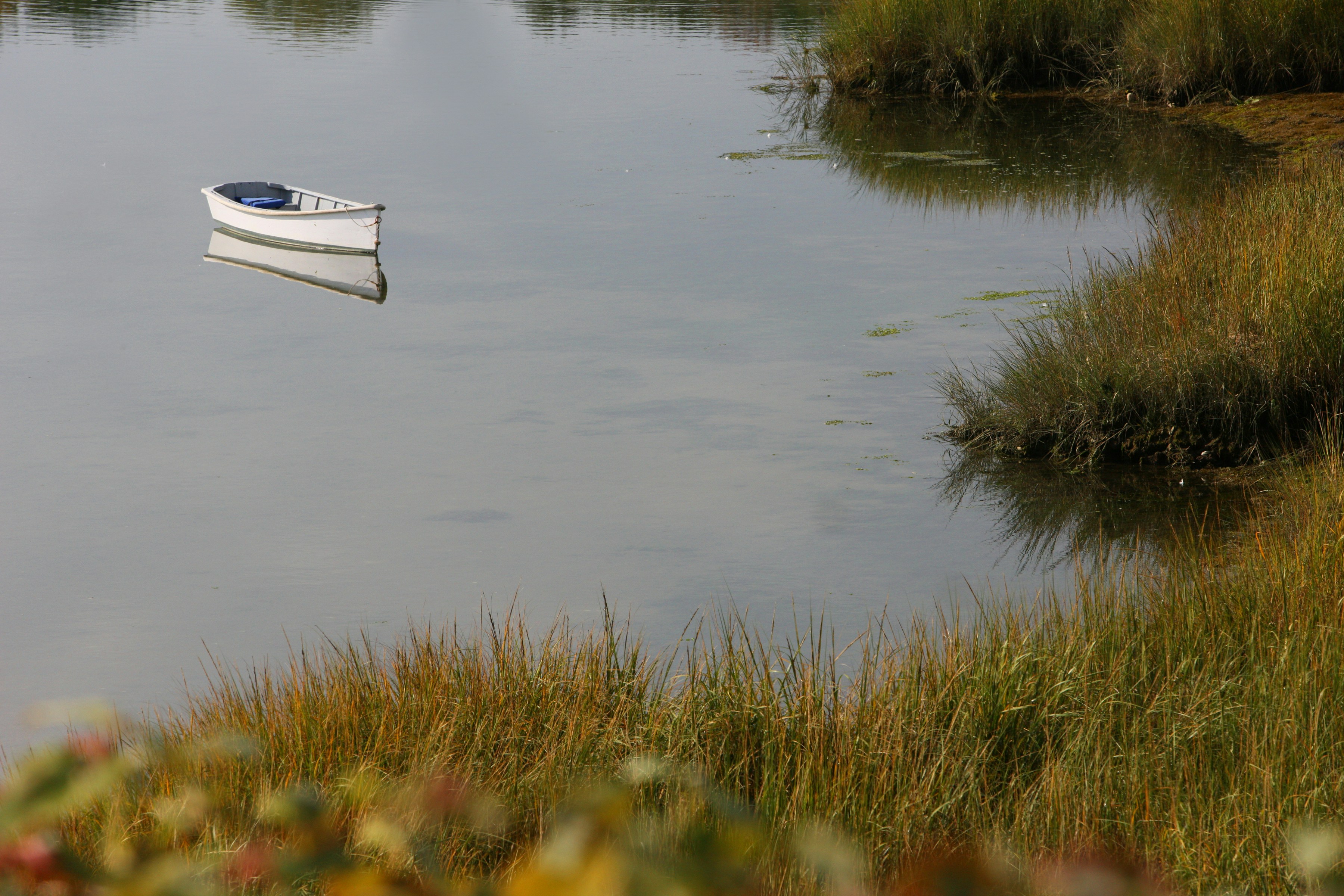 a small boat floating on top of a body of water