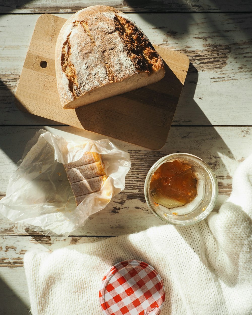 a loaf of bread sitting on top of a wooden cutting board